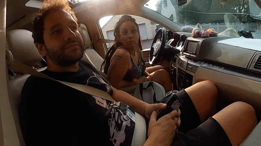 Target Shoplifting Arrest showing Middletown police officers questioning a female suspect near a vehicle.