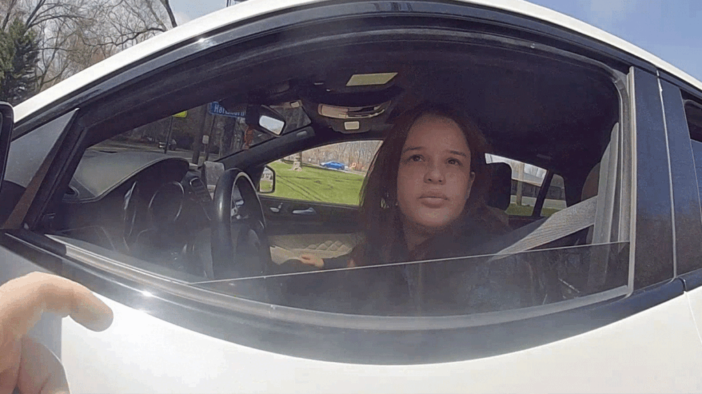 Millburn package theft arrest showing officers searching a white Mercedes-Benz SUV.