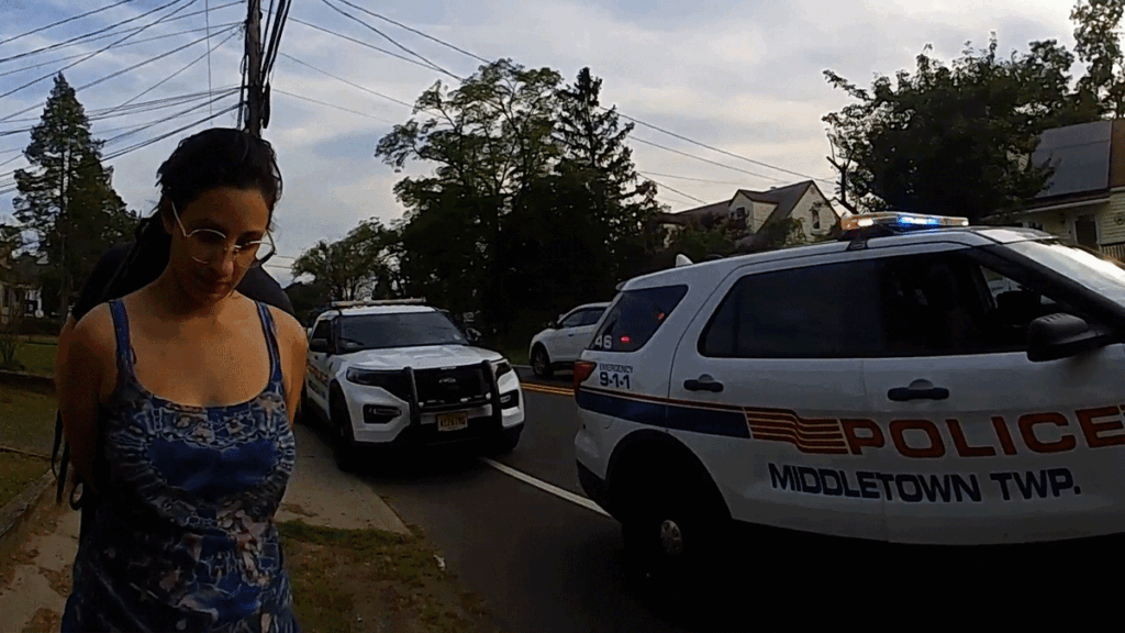 Target Shoplifting Arrest showing Middletown police officers questioning a female suspect near a vehicle.