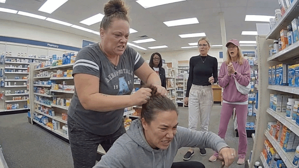 Keansburg Pharmacy assault arrest scene with police reviewing security footage.