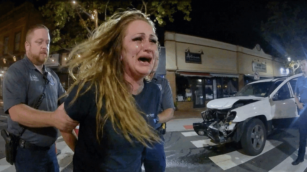 Red Bank DWI arrest scene showing police officer speaking with suspect Emily Wilson on Broad Street.