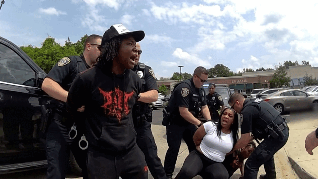 Evesham Lululemon shoplifting arrest showing officers detaining suspects in the Promenade parking lot.