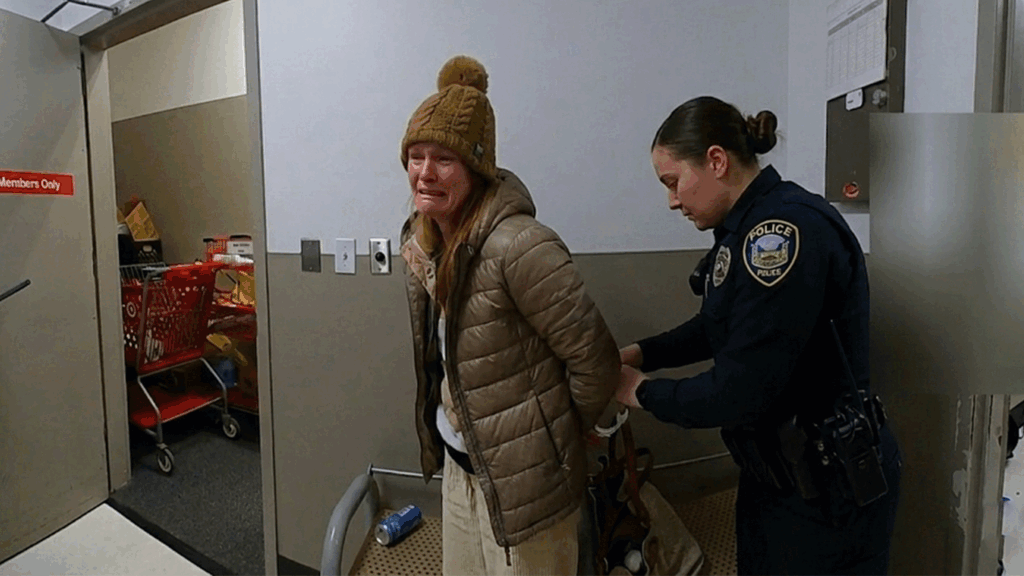 Robyn Karabin Shoplifting Arrest showing Middletown Police Department officers processing the suspect.