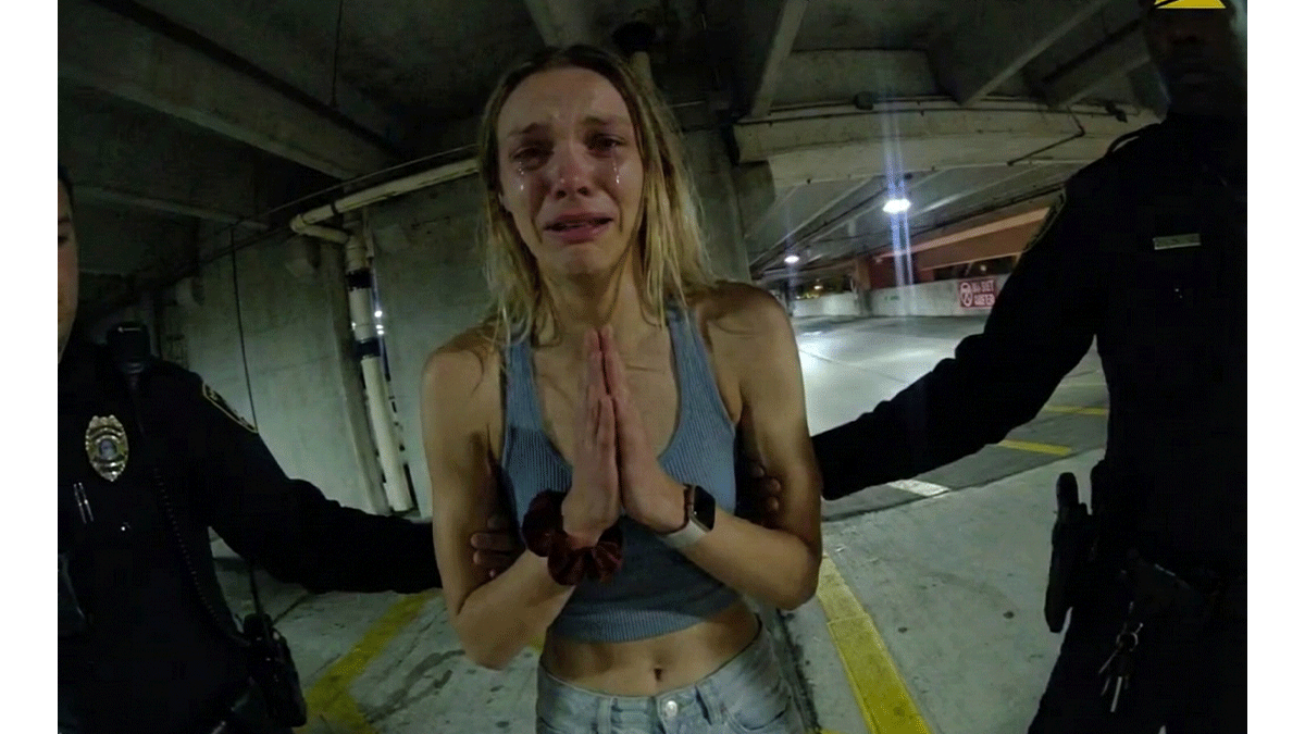 Ainsley Shea Fitzgerald DUI Arrest showing officers investigating a silver Hyundai in a parking garage.