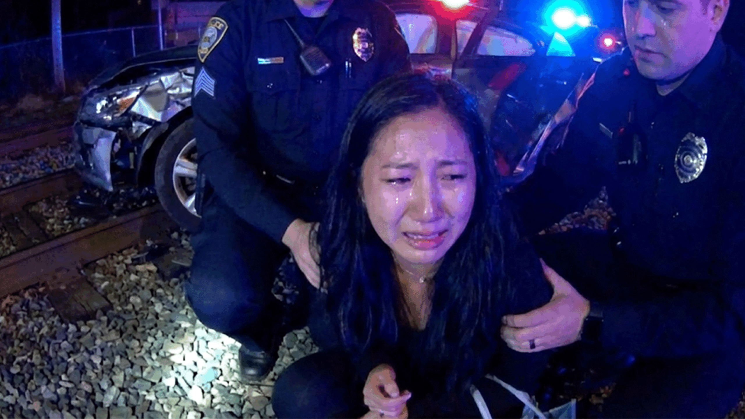 Athens DUI Arrest showing officers questioning a suspect near train tracks.