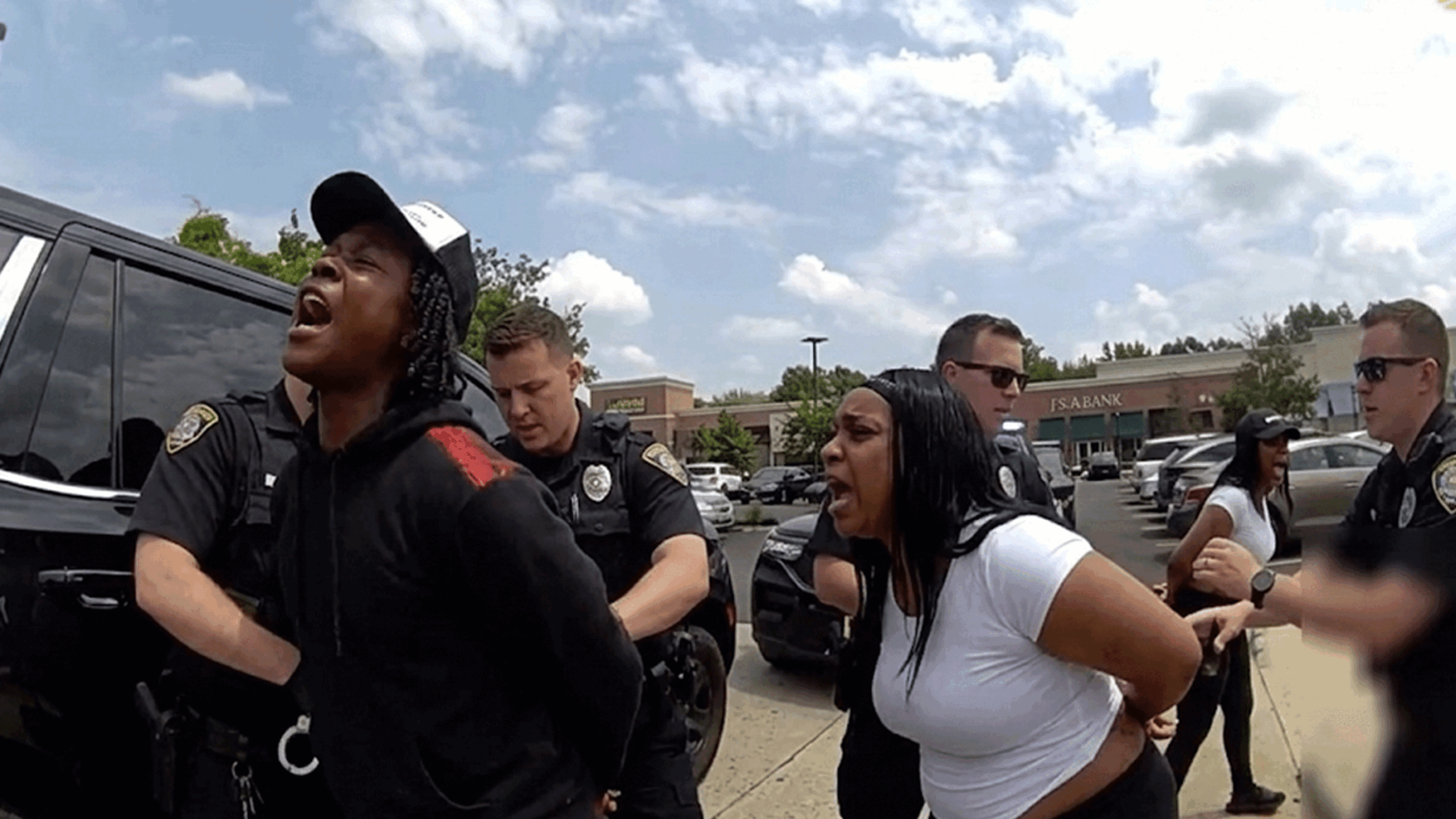 Evesham Lululemon shoplifting arrest showing officers detaining suspects in the Promenade parking lot.